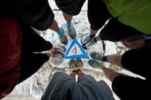 Hiker's feet gathered around Alta Via 1 trail marker