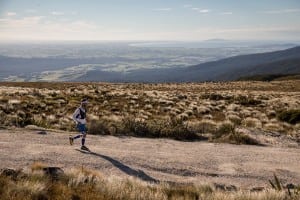 On the penultimate day, Jez runs toward the trail's end point of Bluff, the bump of headland in the back right of the photo. On a side note, here was where Jez interviewed with iRunFar! Photo: Damiano Levati