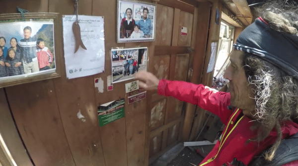 Jordi Tosas looks at pictures of people he knows in Langtang Valley