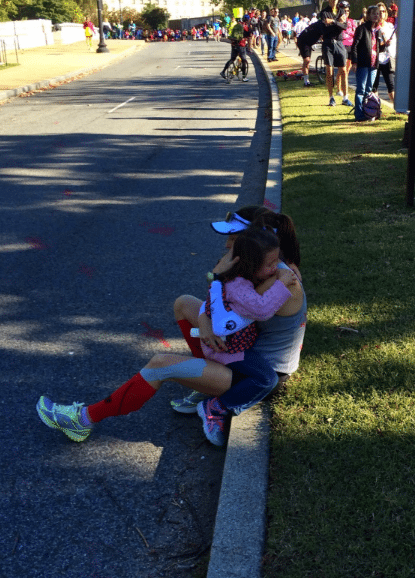 Felicia Wilkerson’s daughter crying and hugging her after Felicia tells her she has to drop at the Marine Corps Marathon.